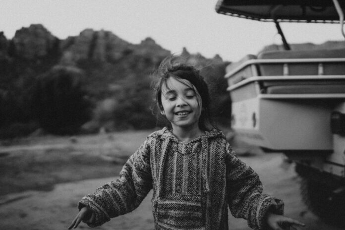 a person smiling with a boat in the background