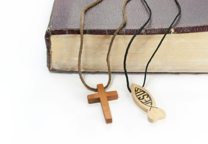 a cross and a book on a white background